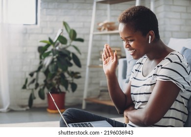 Smiling African American Millennial Woman Resting At Home, Looking At Laptop Screen, Saying Hello, To Her Friends. Business Call. Internet Technology, Digital