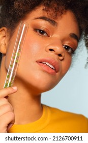 Smiling African American Woman Holding Glass Test Tube With Microgreens In Front Of Face While Posing Isolated Over Grey Background, Copy Space For Text. Superfood And Nutrition Concept