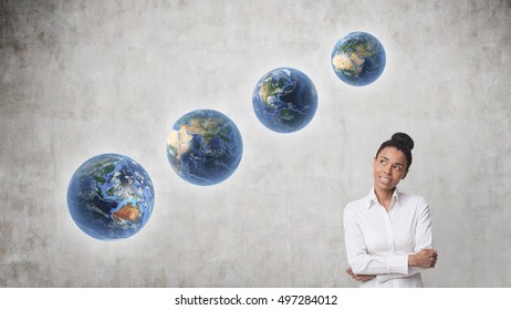 Smiling African American Woman Standing Near Concrete Wall With Four Planets Aligned Diagonally. Concept Of Terraforming. Elements Of This Image Furnished By NASA.