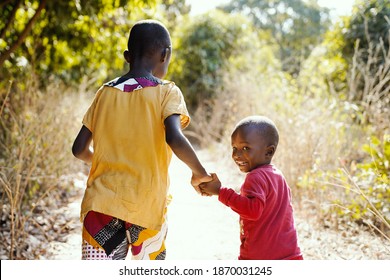 Smiling African Children Walking Outdoors In Typical Tribal Town Near Bamako, Mali (Africa)