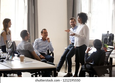 Smiling African Manager Coach Speaking At Diverse Corporate Group Meeting, Female Black Teacher Team Leader Talking To Office Workers At Training Teaching Employees Explaining New Idea, Mentoring