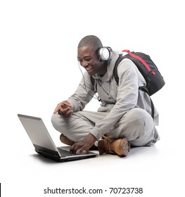 Smiling African Student Using A Laptop