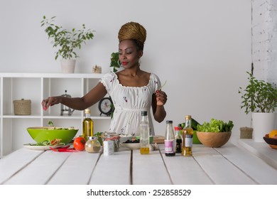 Smiling African Woman Chopping Vegetables For Salad At Kitchen 