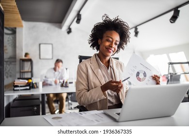 Smiling African woman showing one document, having video call. - Shutterstock ID 1936367335
