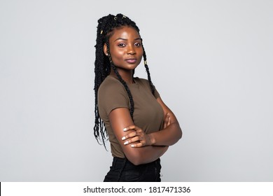 Smiling African Woman Standing With Arms Folded On Gray Background