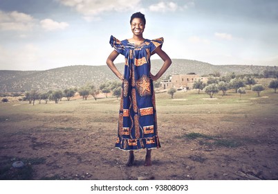 Smiling African Woman In Traditional Clothes On A Desert Field