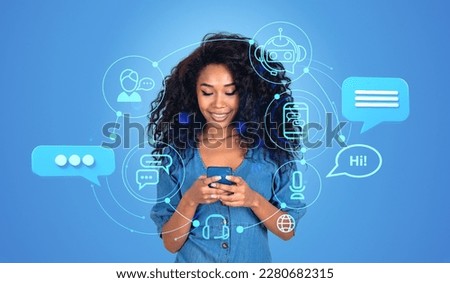 Smiling african woman working with Chatbot online in mobile phone. Chat bot hologram icons, using AI to generate ideas and ask for information. Concept of artificial intelligence