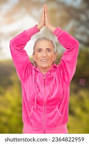 Smiling aged woman in pink sport suit doing yoga over white background - Shutterstock ID 2364822959