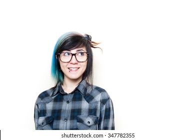 Smiling Alternative Teen Woman In Blue Shirt Looking Up Her Left Isolated