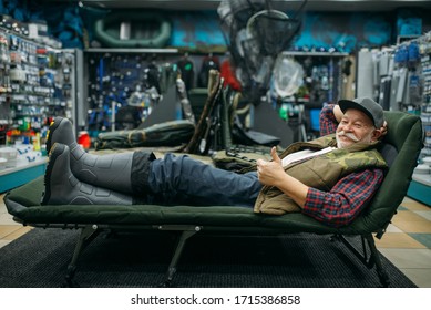 Smiling Angler Lying In Sunbed, Fishing Shop