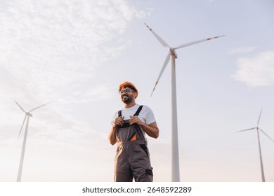 Smiling Arab engineer working on a wind turbine, contributing to sustainable energy production and promoting clean power solutions