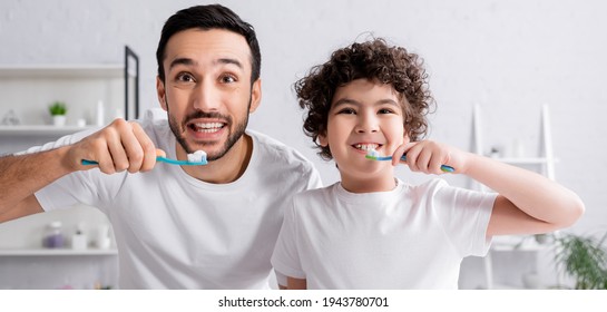 Smiling arabian man and son brushing teeth, banner - Powered by Shutterstock