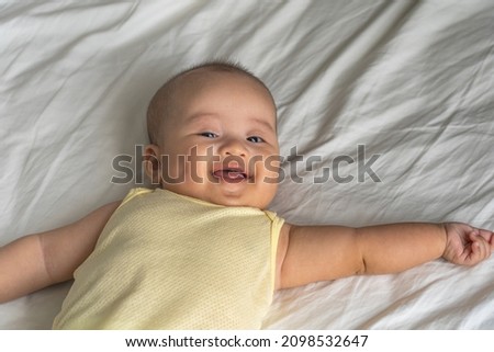 Smiling Asian baby girl with dimples on her cheeks