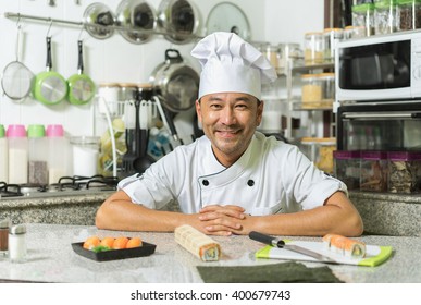 Smiling asian chef  with kitchen background. Focus on the face. - Powered by Shutterstock