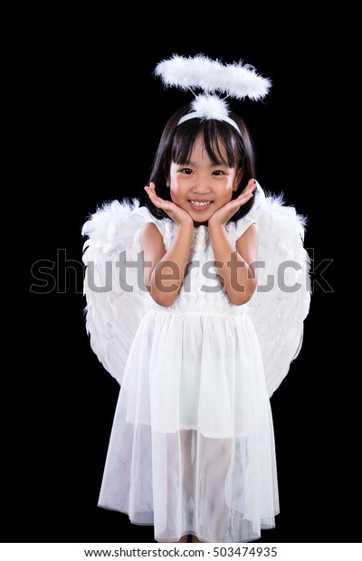 Smiling Asian Chinese Little Angel in dark\
black isolated studio\
background.