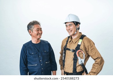 Smiling Asian craftsman and worker duo - Powered by Shutterstock