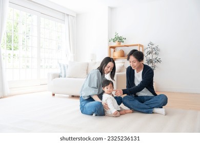 Smiling Asian family at home - Powered by Shutterstock