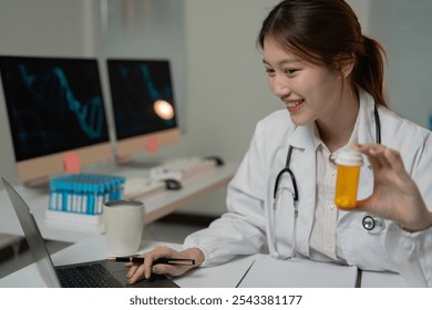 Smiling asian female doctor holding a pill bottle and using laptop while working at modern clinic, healthcare and medical concept - Powered by Shutterstock