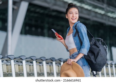 smiling asian female relax carefree casual cloth walking at airport hand hold boarding pass and luggage bag summer travel vacation lifestyle,asia digital nomad expat work and travel