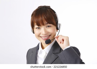 Smiling Asian female switchboard operator.