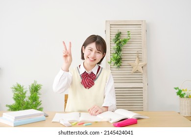 Smiling Asian High School Student Peace Sign Gesture At Home