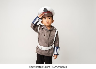Smiling asian little boy wearing a police uniform with whistle  isolated background