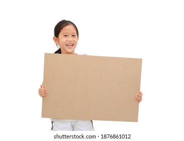 Smiling asian little girl holding empty brown big board for media banner isolated on white background with copy space
