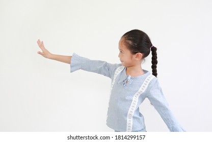 Smiling Asian Little Kid Girl Showing Five Finger Stop Posture And Looking Straight Beside On White Background. Side View.