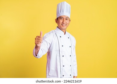 smiling asian male chef with thumbs up on isolated background - Powered by Shutterstock