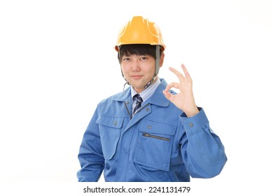 smiling asian male worker in white background - Shutterstock ID 2241131479