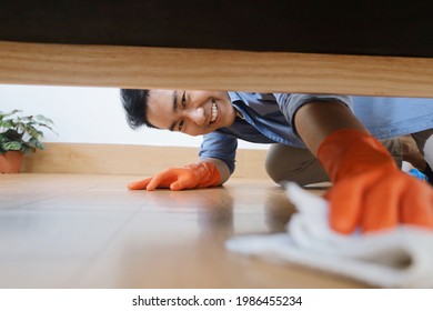 Smiling Asian Man Cleaning House.