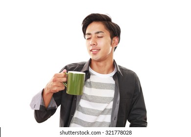 Smiling Asian Man Drinking Coffee.