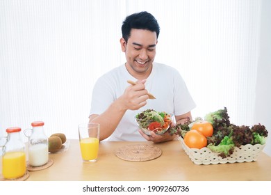 Smiling Asian man joyful with healthy food in the morning