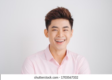Smiling Asian man portrait over white background