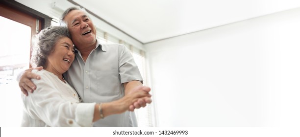 Smiling Asian Senior couple Celebrating Wedding Anniversary with dancing at the house. Chinese Lover. Happy, Romantic, lover. Banner, Panoramic, Copy space. 