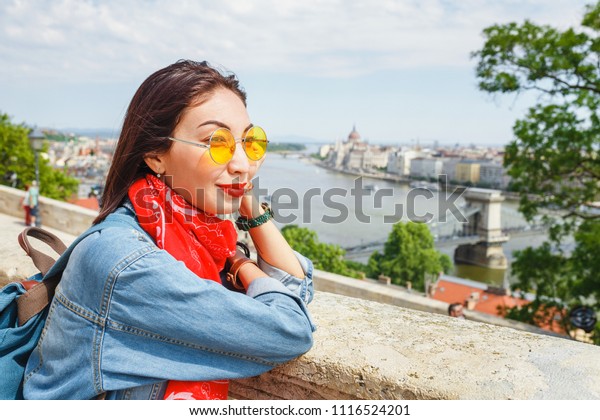 Smiling asian tourist girl\
in Budapest