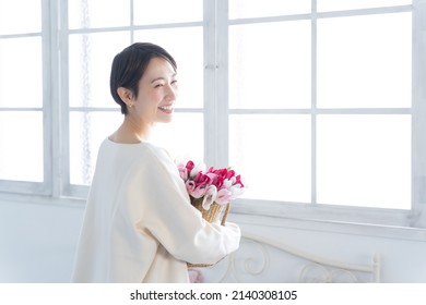 Smiling Asian Woman With Flowers
