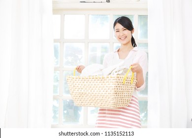 Smiling Asian Woman With The Laundry