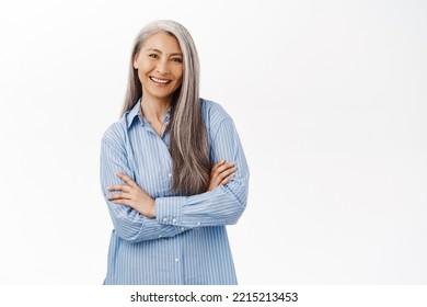 Smiling Asian Woman, Senior Lady Looking With Confidence, Standing In Power Pose Against White Studio Background