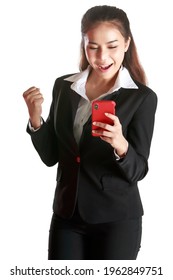 Smiling Asian woman wearing black suit holding hand smartphone to woring and socialmedia showing signs of joy and happiness in white background. Concept happy cheerful and delighted