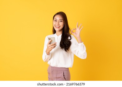 Smiling Asian Woman White Shirt On Yellow Background With Ok Sign