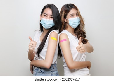 Smiling Of Asian Women Show Thumb Up And Bandage On Arm. Happy Women Feel Good After Received Covid-19 Vaccine. - Powered by Shutterstock