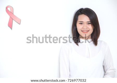 smiling asian women in white shirts with pink breast cancer awareness ribbons over white background.Breast Cancer Awareness campaign.healthcare, people and medicine concept