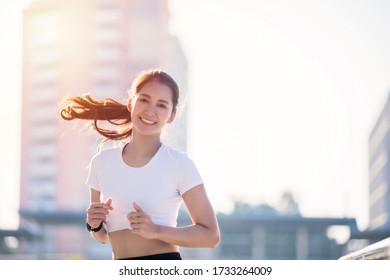 smiling Asian Young fitness sport woman running  and Sportive people training in a urban area, healthy lifestyle and sport concepts