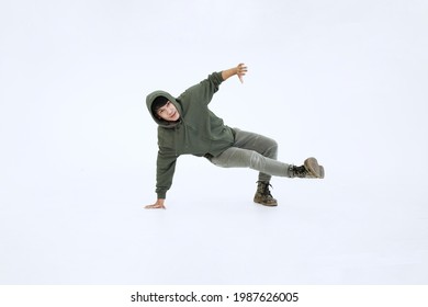 Smiling Asian Young Professional Dancer Man Is Hiphop And Break Dancing By One Leg And Arm Isolataed On White Background In Studio. Education And Sport For Hobbies Concept.