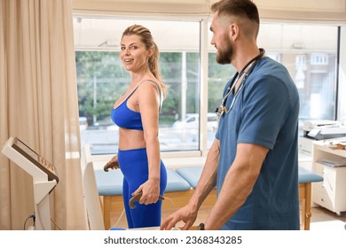 Smiling athletic woman passing neurological exam with special devices - Shutterstock ID 2368343285