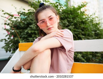 Smiling Attractive American Teenage Generation Z Girl With Dental Smile Looking At Camera Outdoor Headshot. Happy Teen Posing On City Street, Face Lit With Sunshine, Portrait