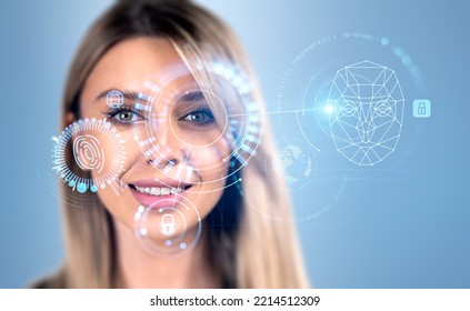 Smiling attractive businesswoman is watching at digital interface with circle hologram with virtual face, globe finger print, padlock, pie diagram with binary code. Concept of facial recognition