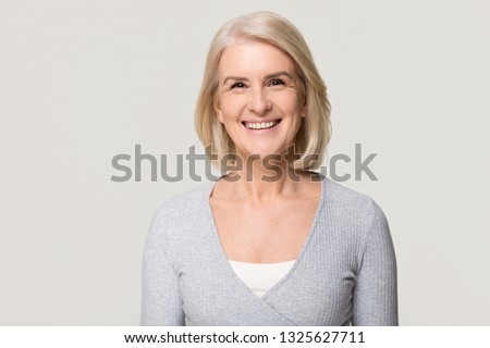 Similar – Image, Stock Photo Old smiling retired woman doing a live streaming near the sea, answering followers and saying hello.