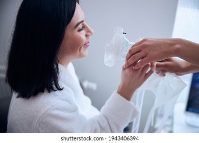 Smiling Attractive Dark-haired Woman Getting Supplemental Oxygen